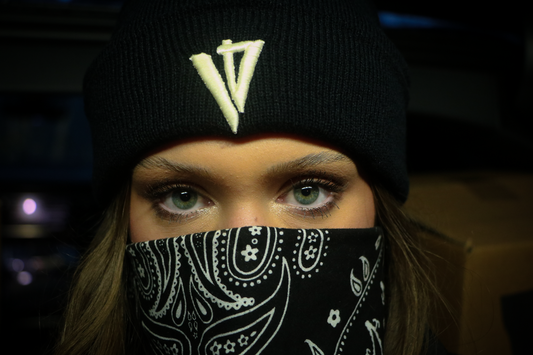 Woman with blue eyes wearing a V4 Beanie and bandana covering her face